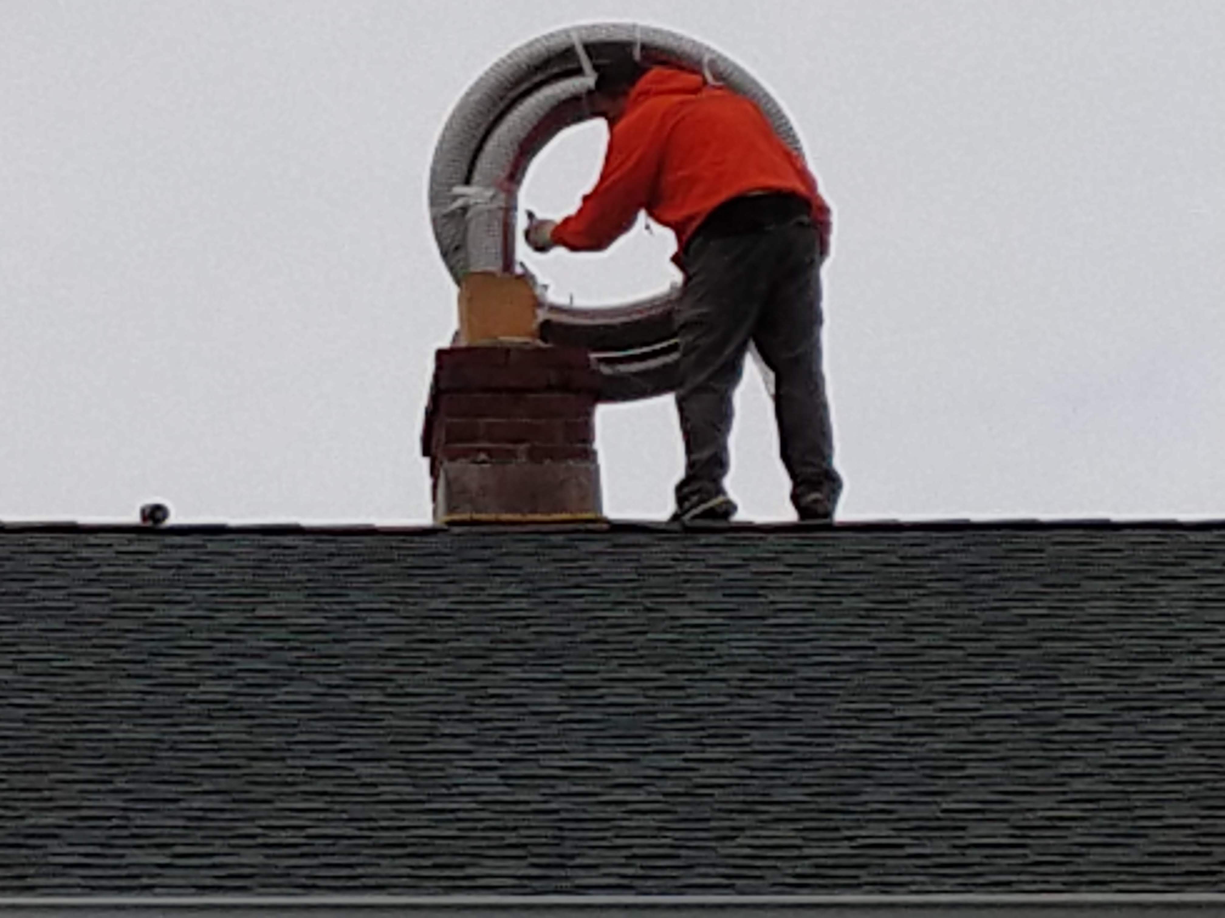 Flexible stainless chimney liner being installed in Oceanside, New York